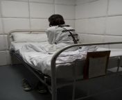 person in retraining coat in hospital bed.jpg from face slapped mental patienti grl bar gand sex