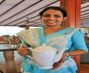 warm welcome sri lanka beautiful young hindu girl festive blue sari smiling woman holding white porcelain teapot 57330875.jpg from cheerful sri lankan aunty