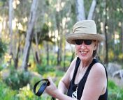 happy smiling mature woman hat forest trail hiking outdoor candid portrait australian her sun protection 80220175.jpg from australian mature
