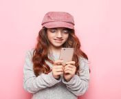 lifestyle tehnology people concept portrait cheerful little girl wearing hat taking selfie isolated over pink 206718033.jpg from little selfie