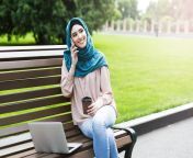 smiling muslim woman hijab talking phone using laptop having coffe breakin park touch concept touch 136498254.jpg from İn touch dick woman