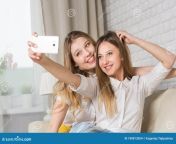 two young girls sitting couch making selfi friend party 109813054.jpg from selfi nued videooy friend gr