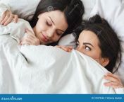 two young women bedroom home lying bed under blanket one women sleeping peaceful another looking her smiling playful 176079556.jpg from lesbian sex during sleep