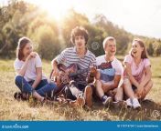 happy female male students enjoy picnic outdoor sit grouped together laugh joke themselves sing songs to guitar admire 119714734.jpg from student enjoy
