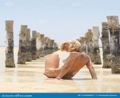 naked seductive woman sitting sand low water wooden sticks 41060897.jpg from naked on the beach sand pussy nice tits and nipples jpg