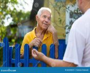 old man talking his neighbour old man talking his neighbour fence country house 263250237.jpg from neighbour oldman