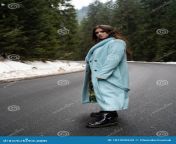 sexy brunette girl walking road winter mountains background glamorous young woman wearing stylish blue long coat poasing 181509932.jpg from naughty brunette on a road to no good jpg