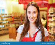 smiling brunette saleswoman standing supermarket 180375097.jpg from saleswoman