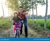 daughter learning to ride bicycle daddy father help teach her 155777740.jpg from step daughter learning to ride c