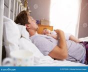 father sleeping bed holding newborn baby daughter 59718265.jpg from fanther sleep