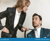 female boss seduces employee young naughty businesswoman holding jacket collar businessman sexual harassment concept 189252255.jpg from old boss sex with young