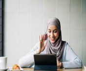 content muslim female in hijab waving hand and talking on video chat via tablet while sitting at table in cafe adsf24803.jpg from hijab chat