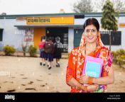 indian rural woman teacher holding book standing in village school jb60e4.jpg from telugu village teacher student