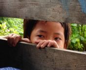 nepalese child peeping through fence on trip with 360 expeditions on trek manaslu circuit nepal asia.jpg from peeping asia