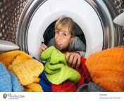 4863302 woman reaching inside a washing machine or dryer at laundry photocase stock photo large jpeg from woman un washed