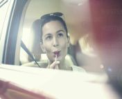 young woman licking lollipop while day dreaming in car during road trip ajof00817.jpg from ทริน้องไอซ์ อมยิ้มทริป lollipop trip