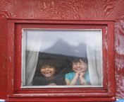 two local kids laughing in window photo david trood visit greenland 907x1024.jpg from kalaallit inuit greenl