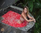 118542654 sweet girl in swimsuit sitting in pose in a pond full of flower petals.jpg from sixy pond