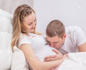 117546980 young husband kisses to the belly of his pregnant wife on the bed.jpg from husband wife belly kis