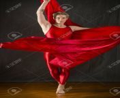 93237138 active young woman dancer with short blonde hair in a red unitard dramatically swirling red fabric.jpg from red blonde dancing
