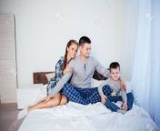 136616649 mom dad and young son sleep on the bed in the bedroom.jpg from dad sleeping mom son romance
