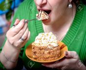 102700479 the woman opens her mouth to eat a piece of pie which she holds on a plate.jpg from oral pie