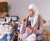 muslim woman smoking shisha at home and texting with her friends muslim young woman enjoying while smoking nargile arab girl smoking hookah photo.jpg from indian woman smoking sex videosাহির চà