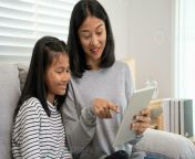 mother teaching lesson for daughter by tablet mother and child laughing happily do homework with kind mother help encourage for exam asia girl happy homeschool mom advise education together photo.jpg from mom teac