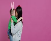 cute mother and child showing love to each other in studio mom hugging and kissing her small toddler son with bunny ears adorable little family laughing together and having fun camera a video.jpg from funny cute mom kiss