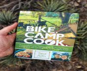bike camp cook book held in hand.jpg from bike cook