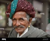 old indian rajasthani man with green and brown rajasthani turban pagari smiles for the camera 2caf0gb.jpg from rajasthani saxi vido गाँव की लडकी की