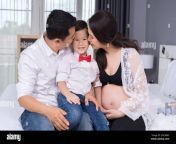 happy family concept pregnant mother and father kissing kid boy on bed 2ac9bk5.jpg from japanese son pregnant his mom japanese son pregnant his mom