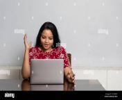 a young indian woman sitting in her living room doing work from her laptop working from home concept indian housewife checking email 2c4569y.jpg from house wife and home worker xxx videos