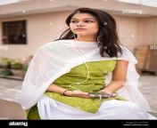 beautiful happy indian late teen girl listening music on smartphone through earphones and enjoying fresh air in outdoor on roof at day time 2c7ftj0.jpg from indian salwar suit sex tamil video amma megan