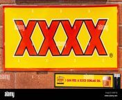 brisbane australia december 8 2009 red on yellow xxxx beer sign against red brick wall slogan added i can feel xxxx coming on 2b4k1nj.jpg from wwww xxxx xxxx