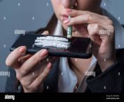 portrait of a young cocaine girl using coca powder and a straw from a dollar the problem of drug use in women street drug use habit addiction to d 2b04mkn.jpg from xxx kidnap girl sleeping drug xxxangla xxzবাং¦