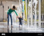 birmingham uk 12th apr 2020 twelve year old mia takes her 18 month old brother jasper for their daily exercise walk through the fountains in centenary square birmingham city centre their family lives nearby easter sunday has begun as a warm and sunny day parental permission granted credit peter lopemanalamy live news 2be524r.jpg from japan rep 18yer