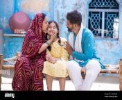happy rural indian family smiling while sitting on traditional bed at village home mother is sari hug and kiss her cute little daughter and father lo 2gda78m.jpg from husband wife bed village romce