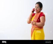 woman in saree smiling while talking on the phone happily 2dbfymh.jpg from saree talk