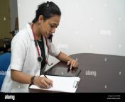 a south indian female doctor in 30s with tablet and prescription board with white coat and red stethoscope in white backgroundonline medical consultation 2g5f90r.jpg from south indian lede dcotor and gentes paicentes xxx