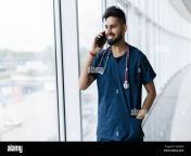 young indian doctor talk phone in hospital consulting doctor medical staff in clinic bearded man with smartphone healthcare professional concept 2g6f82a.jpg from doctor and nurse peshawar xxx