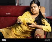 an indian housewife woman watching television holding remote and mobile phone in hands sitting on sofa 2g92yar.jpg from indian house wife aunty saree sex romance hotm house wife and sex vidoeshমৌসুমির চোদাচুদি sexy hot mom son bed room xxxजीजा और साली की च