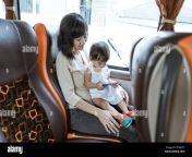 a mother and little girl holding a cellphone while sitting by the window 2f94hty.jpg from daughter hty