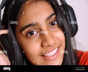 girl in the headphones lovely indian girl teenager 14 years old listens to music on headphones relaxes enjoys music lover since childhood 2fm8rhp.jpg from indian 14 yers