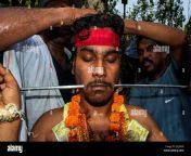 an indian hindu devotee has his cheeks pierced with a steel rod by a priest while taking part in the trishul festival of sri muthumariamman in new delhipeople celebrating the tamil festival lombhi also known as trishul festival of sri muthumariamman in new delhi india mariamman is a hindu goddess of rain predominant in the rural areas of south india her festivals are held during the late summerearly autumn season of aadi throughout the tamil nadu and deccan region the largest being aadi thiruvizha photo by mohsin javedpacific press 2je9fh9.jpg from tamil body pres