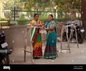 two maids standing and chatting on the street 2m45hrx.jpg from indian village servant a