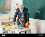 a grandfather and a son are learning in class old and young concept of a retirement age portrait of confident old male teacher 2pk6c2d.jpg from old young com class