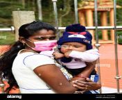 mother with mouth guard and child with playboy cap sri lanka 2pkd7h6.jpg from mother and son sinhala