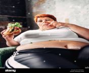 fat woman sits in a chair and eats sandwich overweight fatty and bulimic m20x61.jpg from big fatt woman