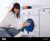 woman putting dirty cloth into washing machine r6yj5t.jpg from woman un washed